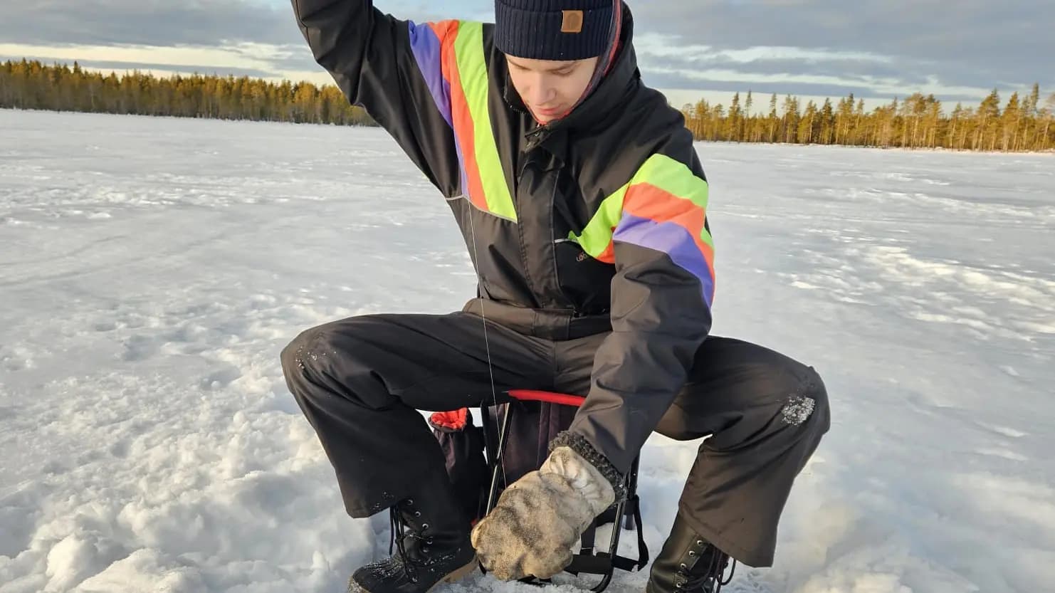 Man ice fishing in Lapland