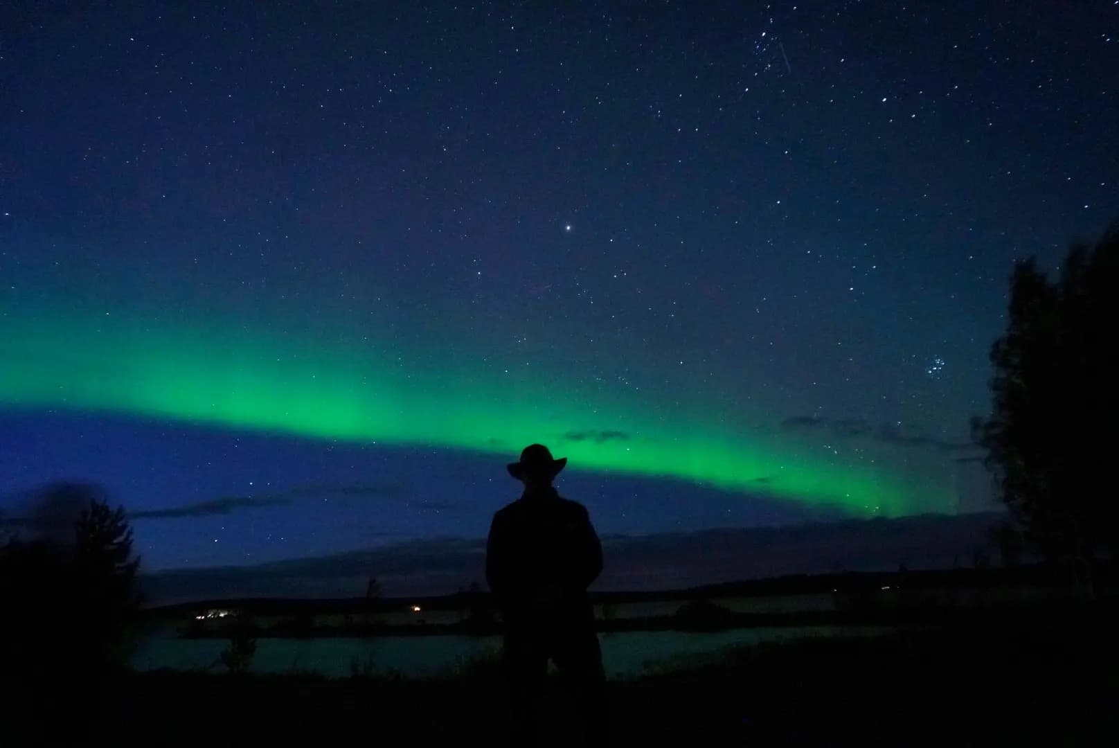 A silhouette of guy in front of northern lights