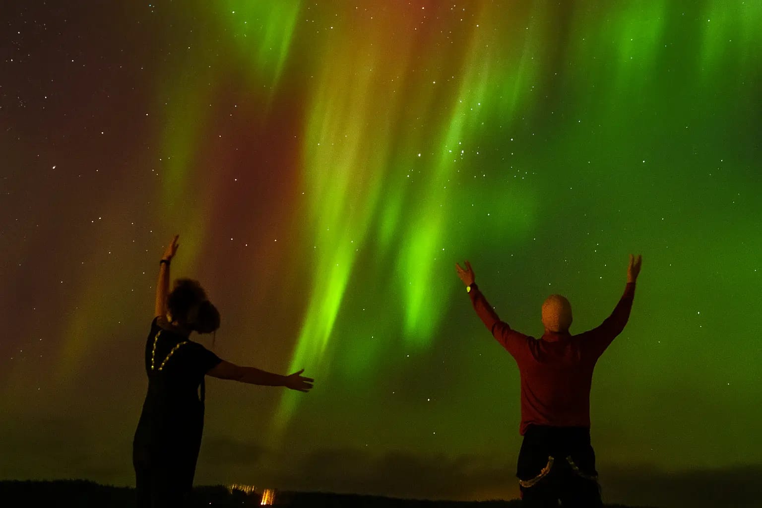 Northern lights, two guys standing in Lapland